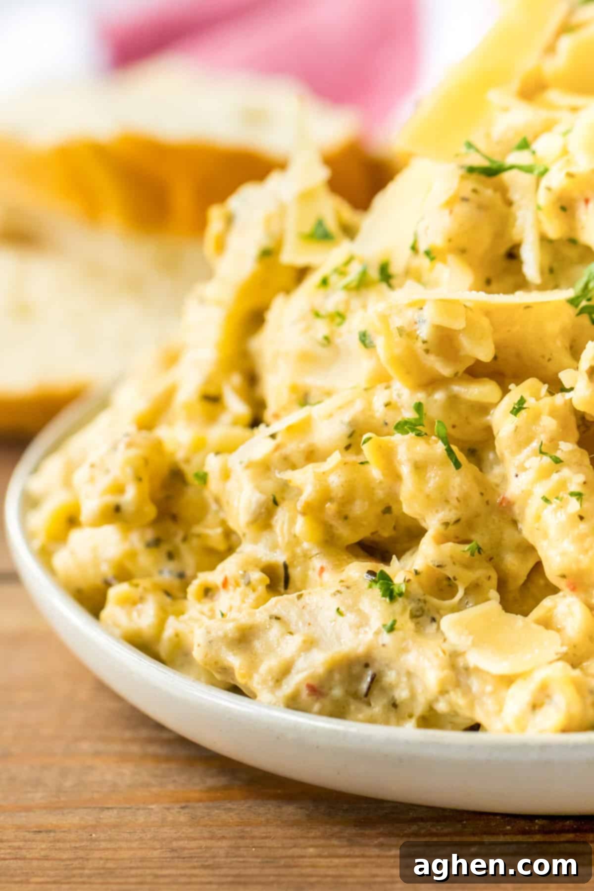 Creamy Crockpot Garlic Parmesan Chicken Pasta 7 Creamy crockpot buffalo wild wings garlic parmesan chicken pasta served on a white plate.
