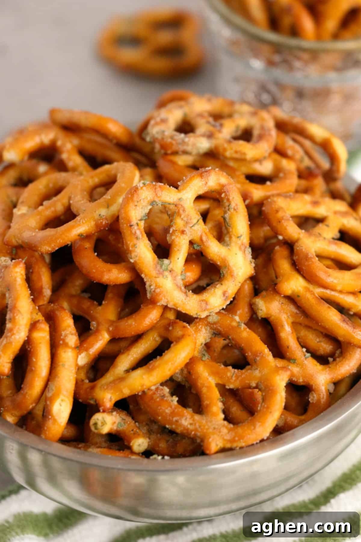 Garlic ranch pretzels in a shining silver bowl, perfectly seasoned and ready to eat.