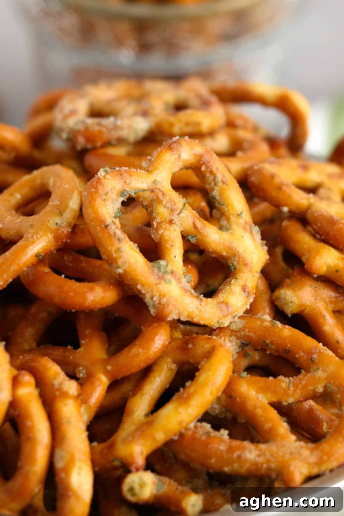 A close-up of a pile of perfectly coated Garlic Ranch Pretzels in a bowl, showing the vibrant seasoning.