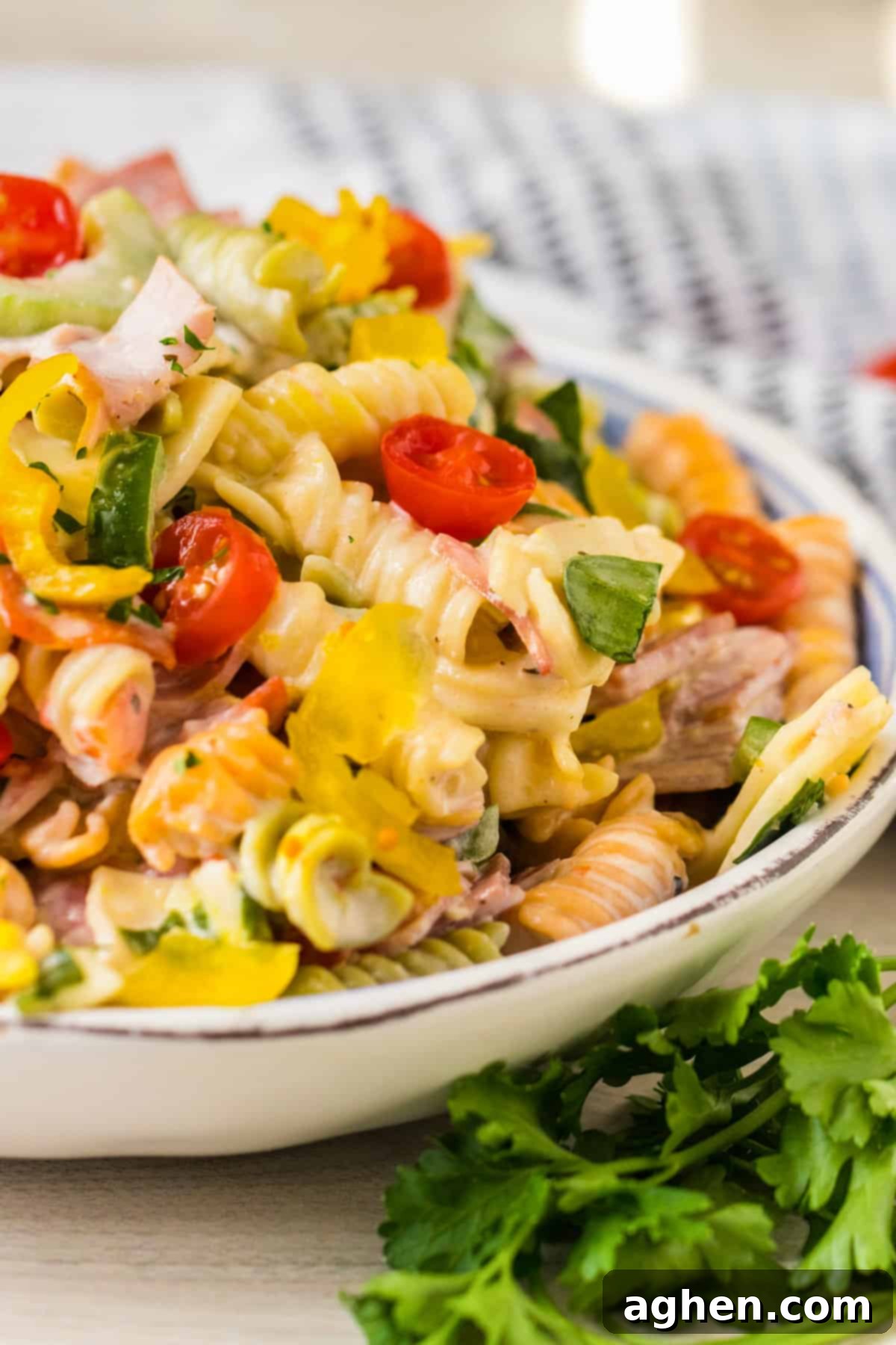 Pasta salad with Italian hoagie ingredients served in a large bowl.