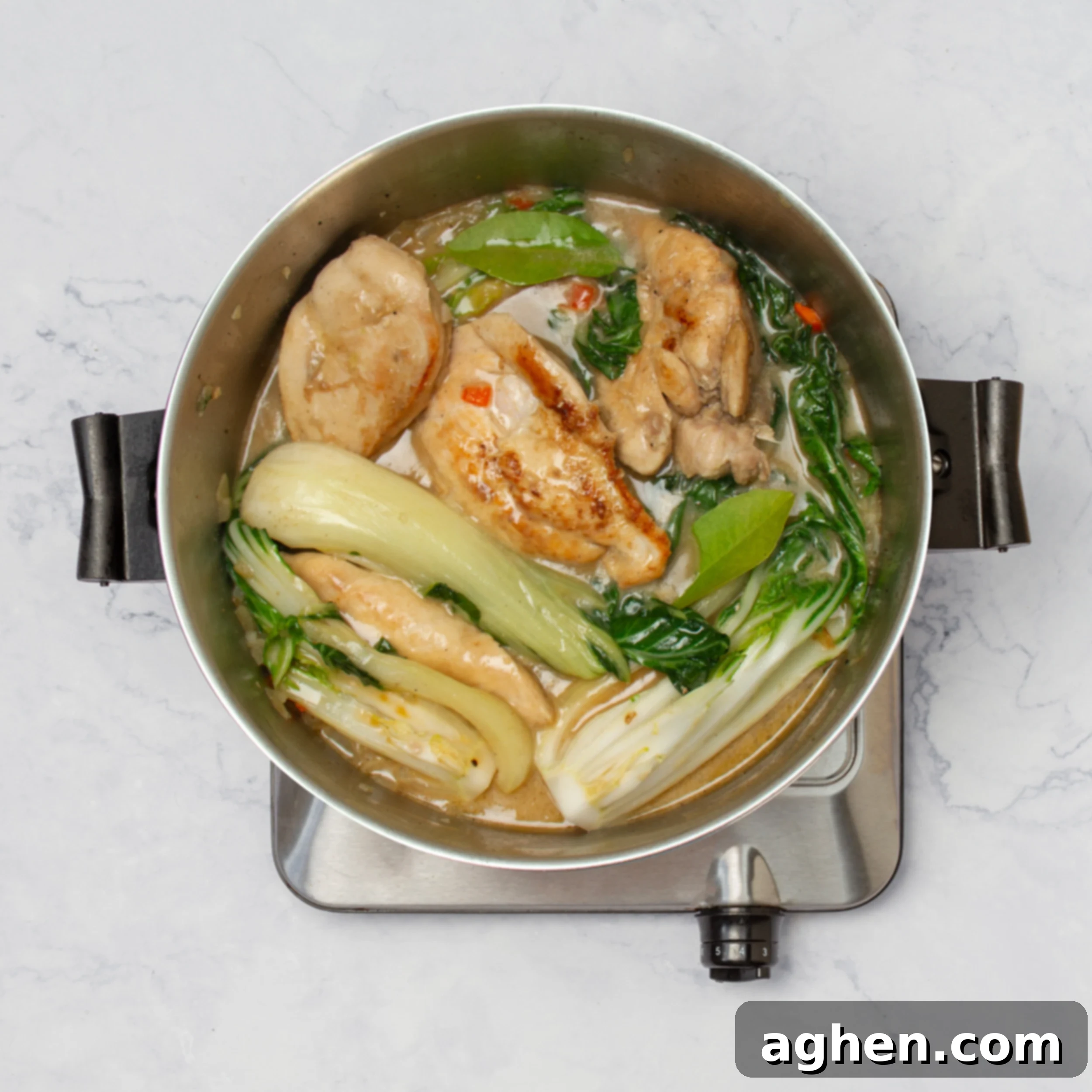 Tropical Coconut Lime Chicken 6 Chicken and bok choy simmering in the flavorful coconut lime sauce, absorbing all the delicious spices.