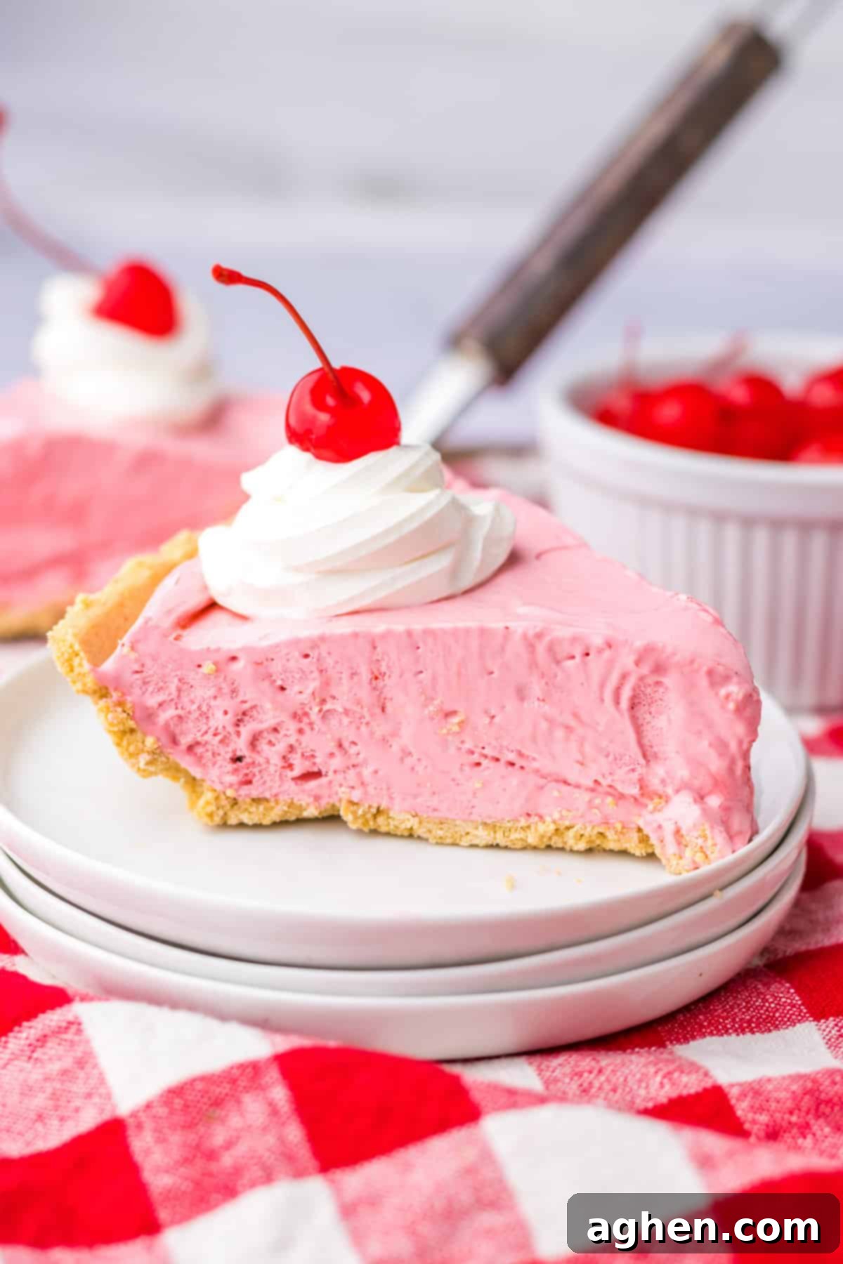 No-Bake Kool-Aid Dream Pie 2 Slice of no bake kool aid pie with cool whip and cherry on top.