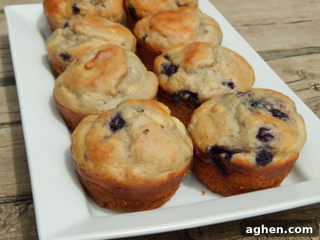 Close-up of a blueberry lemon yogurt muffin, showing its moist texture and juicy berries