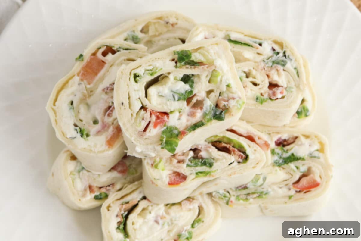 Creamy Ranch BLT Swirls 8 Top-down view of ranch pinwheels stacked on a white plate, showcasing their inviting presentation.