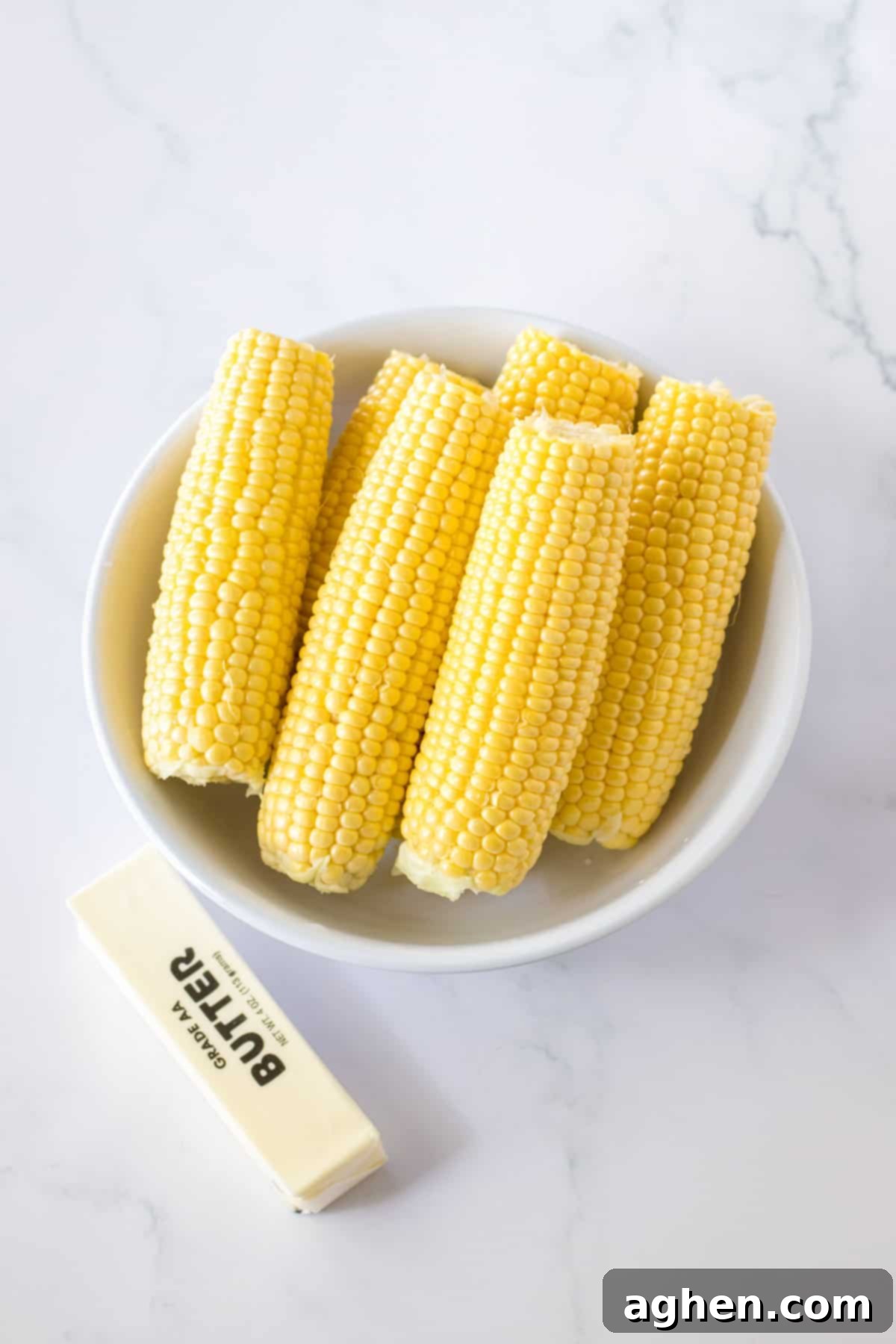 Effortless Slow Cooker Corn 4 Corn on the cob and stick of butter.