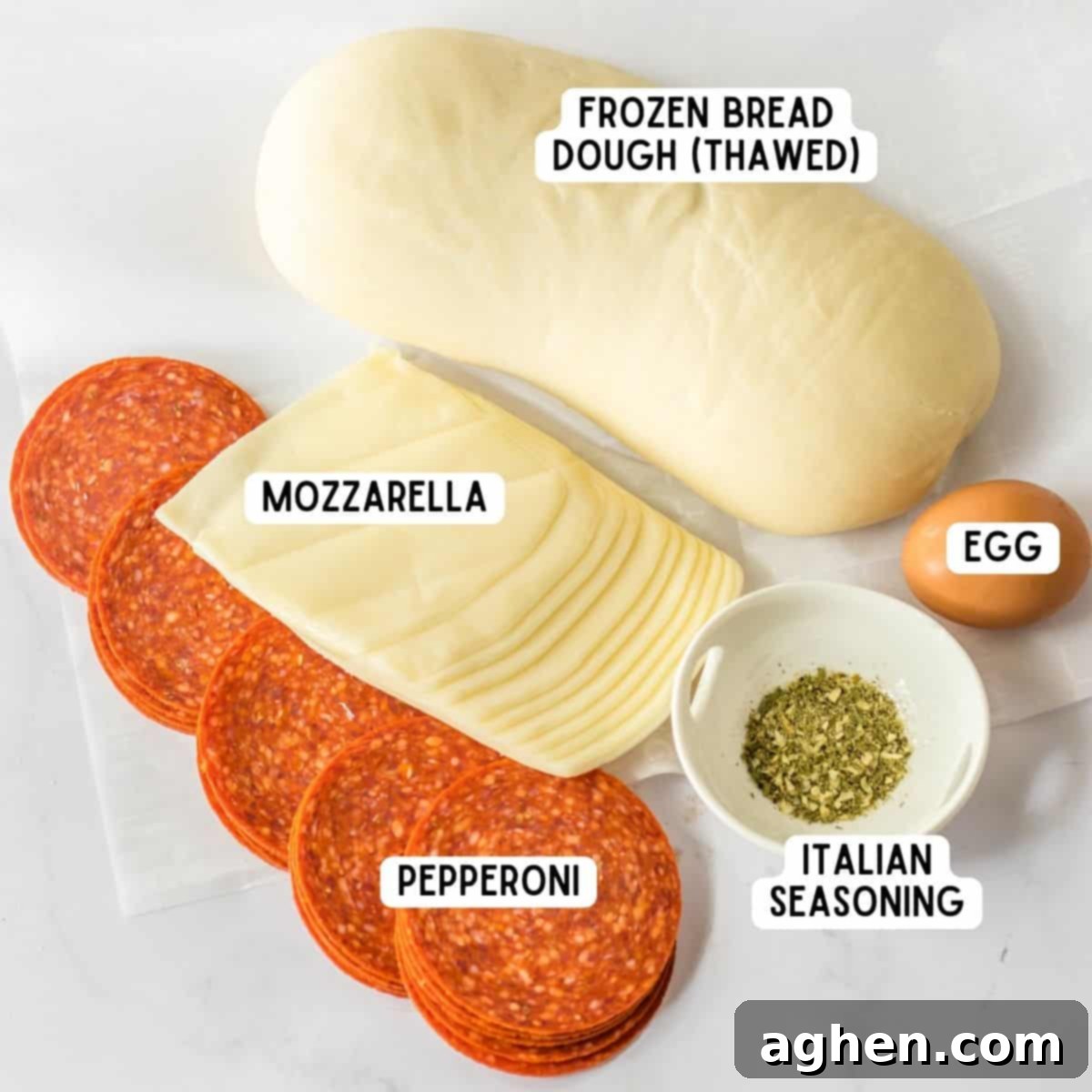 Pepperoni bread ingredients: frozen bread dough (thawed), slices of mozzarella cheese, pepperoni, Italian seasoning, and an egg.