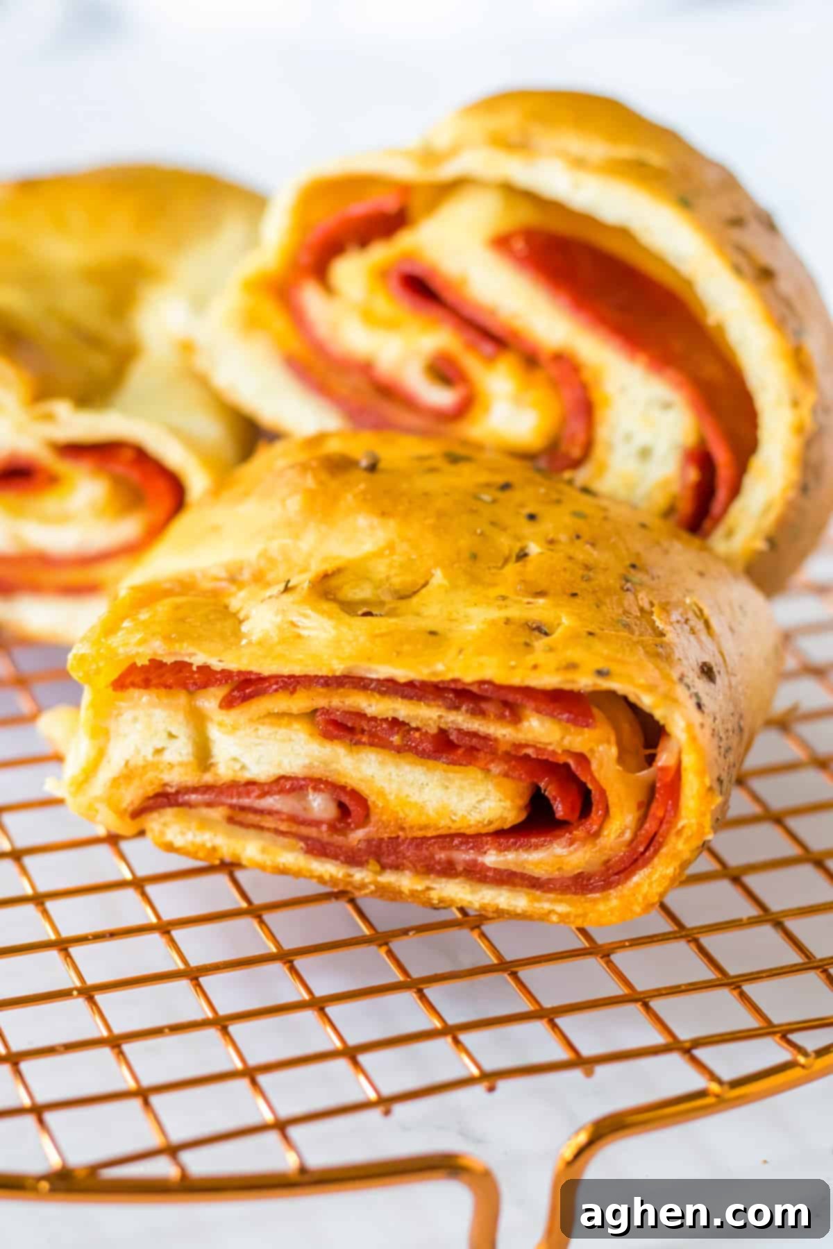 Slices of pepperoni and cheese bread on cooling rack.