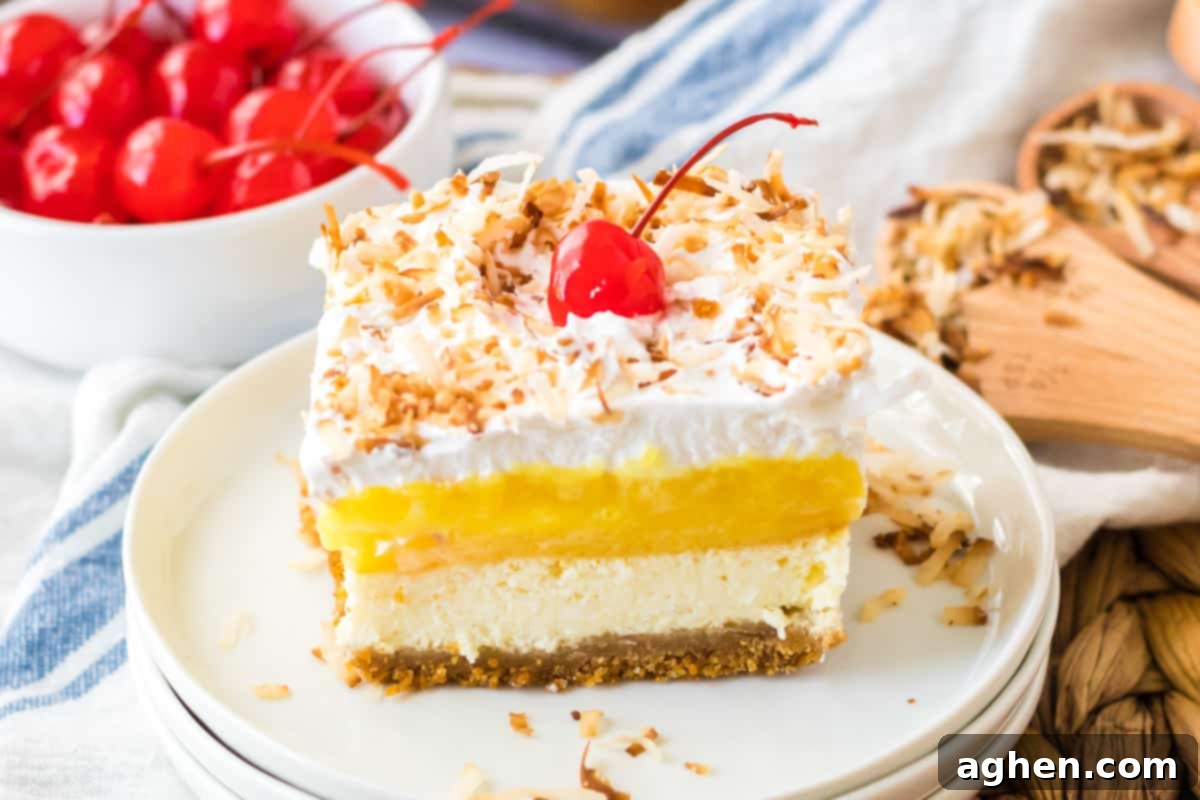 Pina Colada Dream 11 Pina colada lush dessert sliced into a square and served on a white plate.