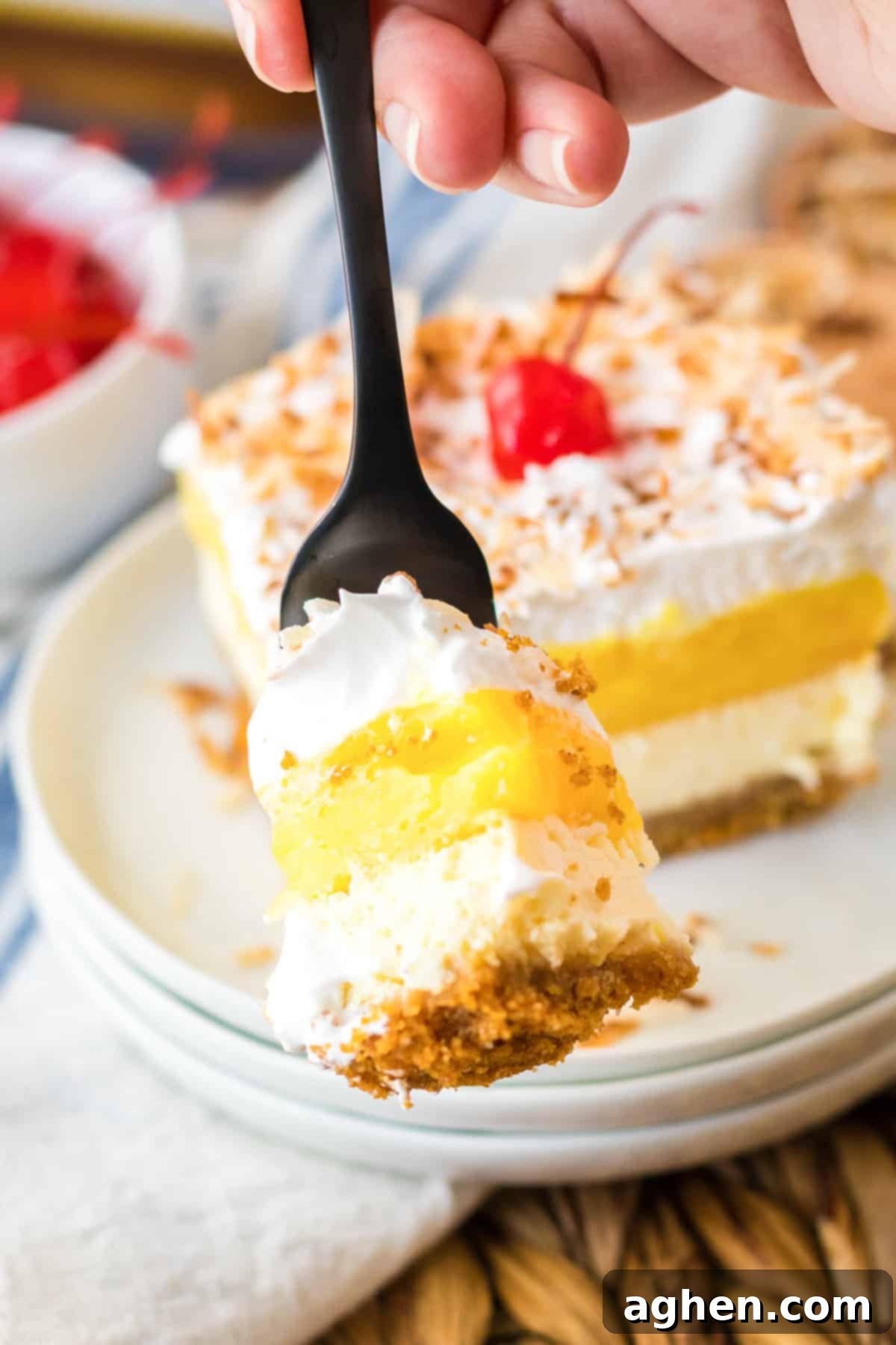 Pina Colada Dream 8 Fork-full of pina colada cheesecake bars.