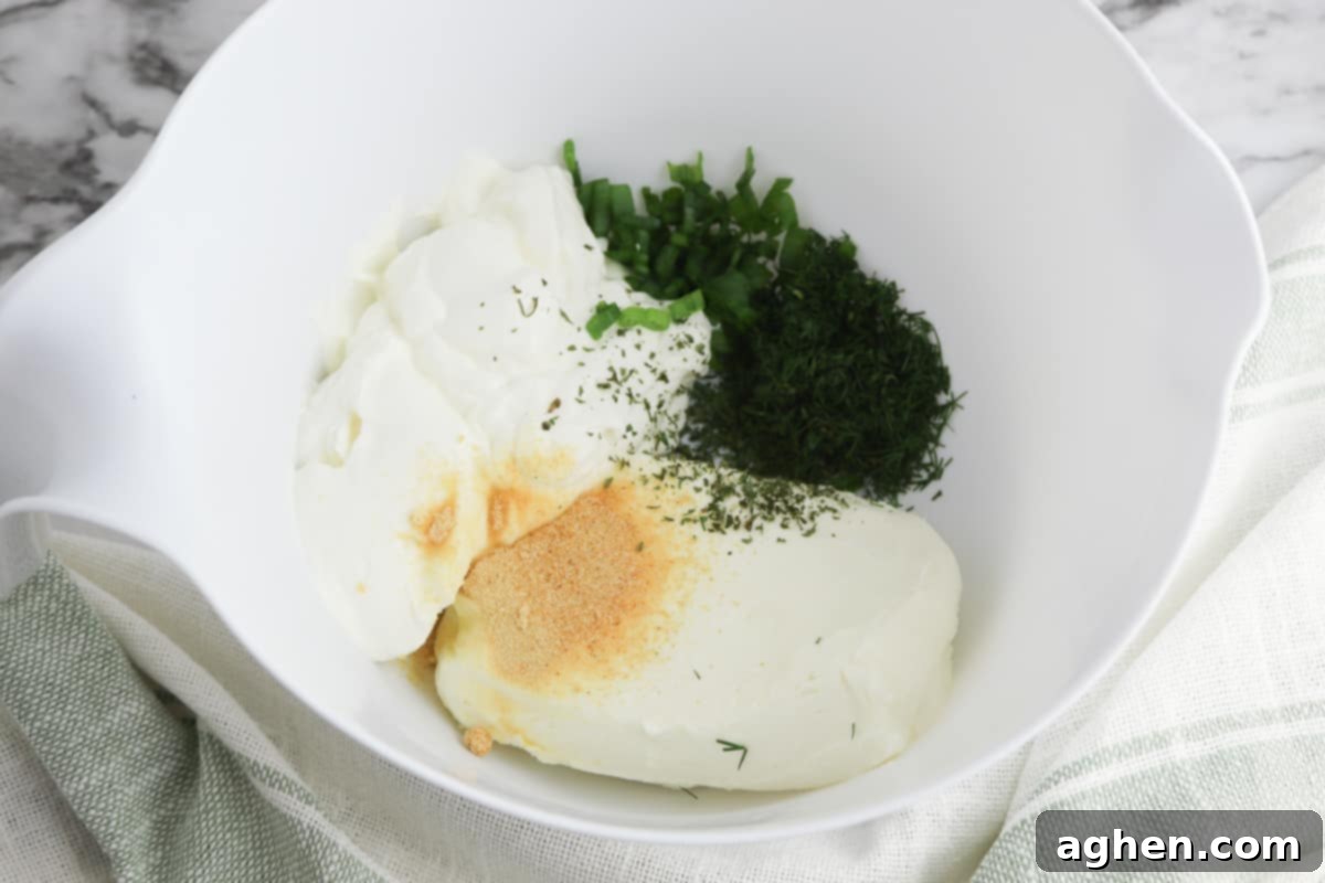 Dill dip ingredients all in a mixing bowl.
