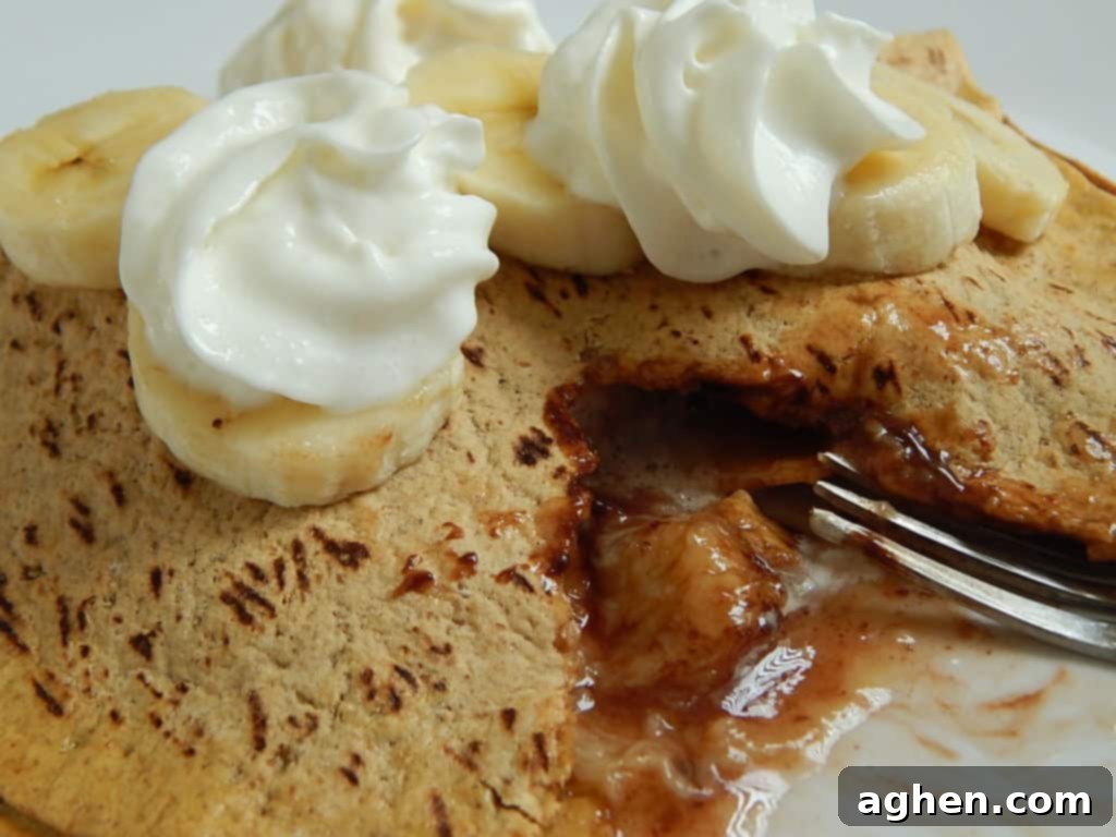A delicious golden-brown banana s'mores Flatout pocket with melted chocolate and marshmallow oozing out, ready to be enjoyed.