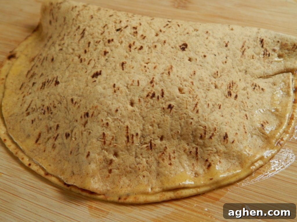 A Flatout s'mores pocket folded and sealed with egg wash, showing the crimped edges.