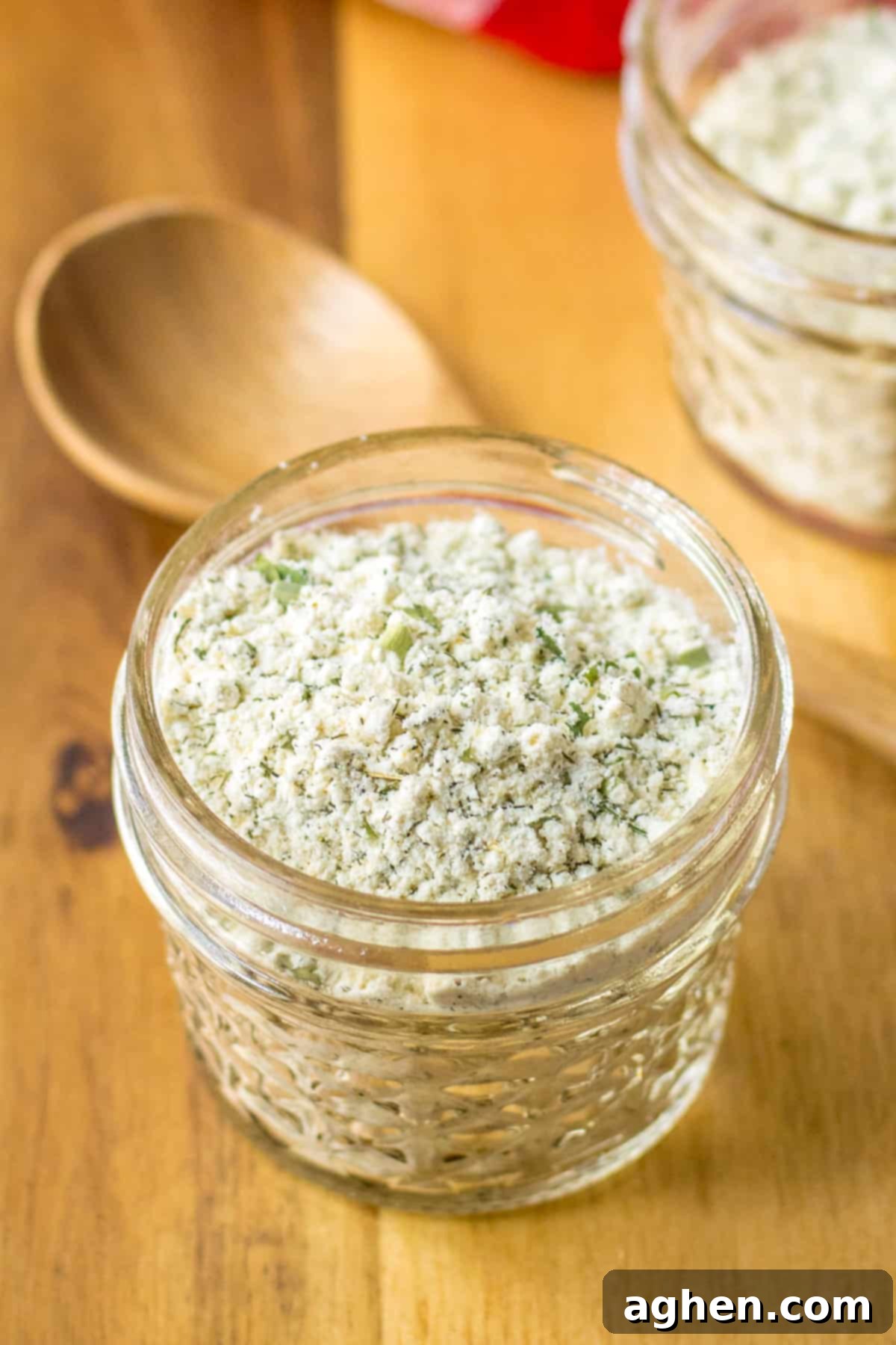 Homemade Ranch Seasoning Mix 2 Homemade ranch seasoning mix in a glass jar with a wooden spoon next to it.