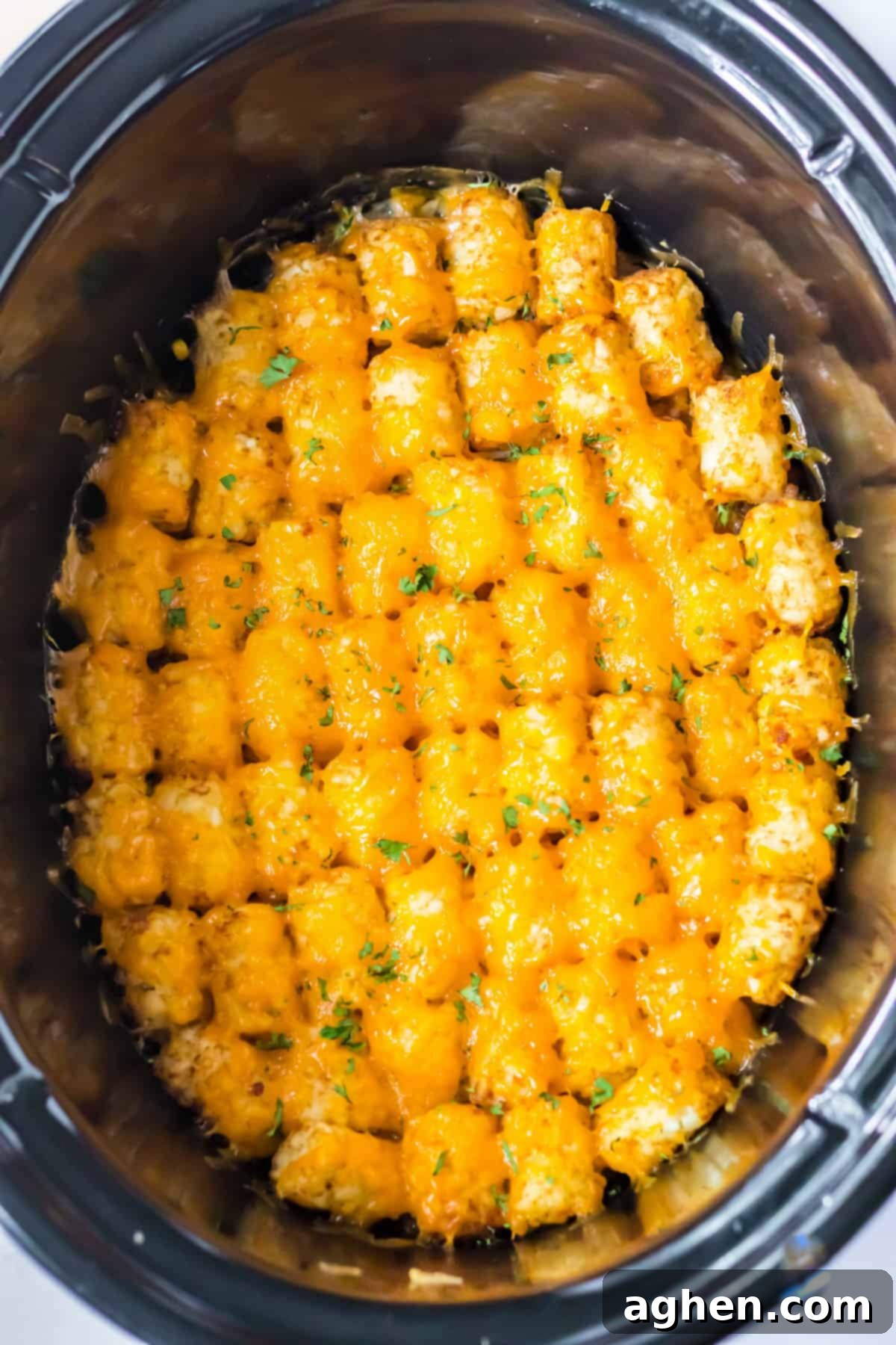 Effortless Tater Tot Comfort 2 Slow cooker tater tot casserole topped with melted cheese.