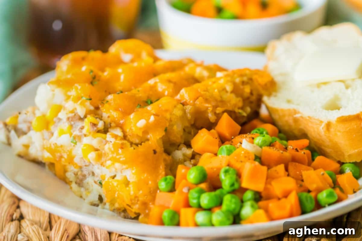 Effortless Tater Tot Comfort 11 Plated portion of crock pot tater tot hot dish with veggies and buttered bread.