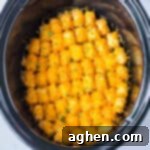 Effortless Tater Tot Comfort 13 Slow cooker tater tot casserole with melted cheese and ground beef.