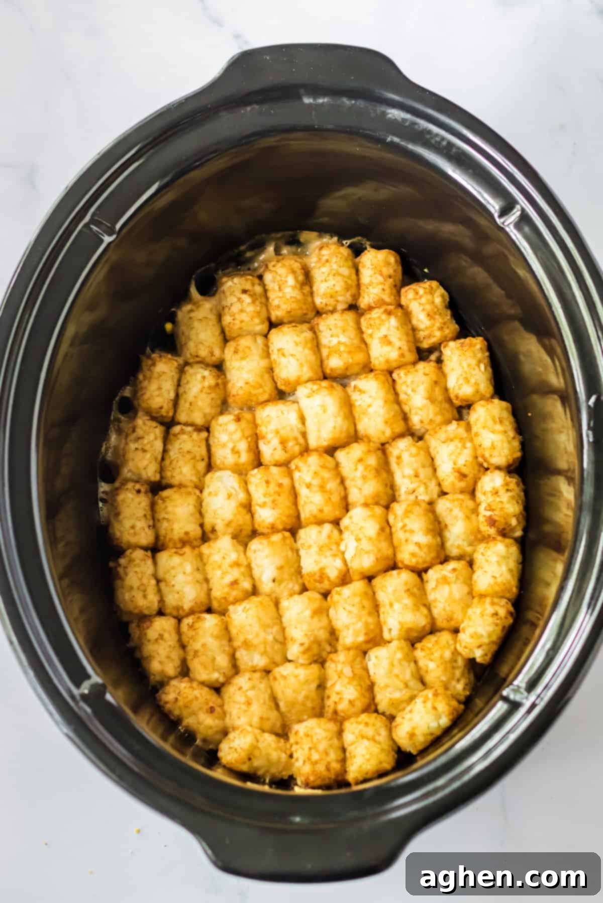 Effortless Tater Tot Comfort 6 Tater tots in a neat and even layer in crock pot.