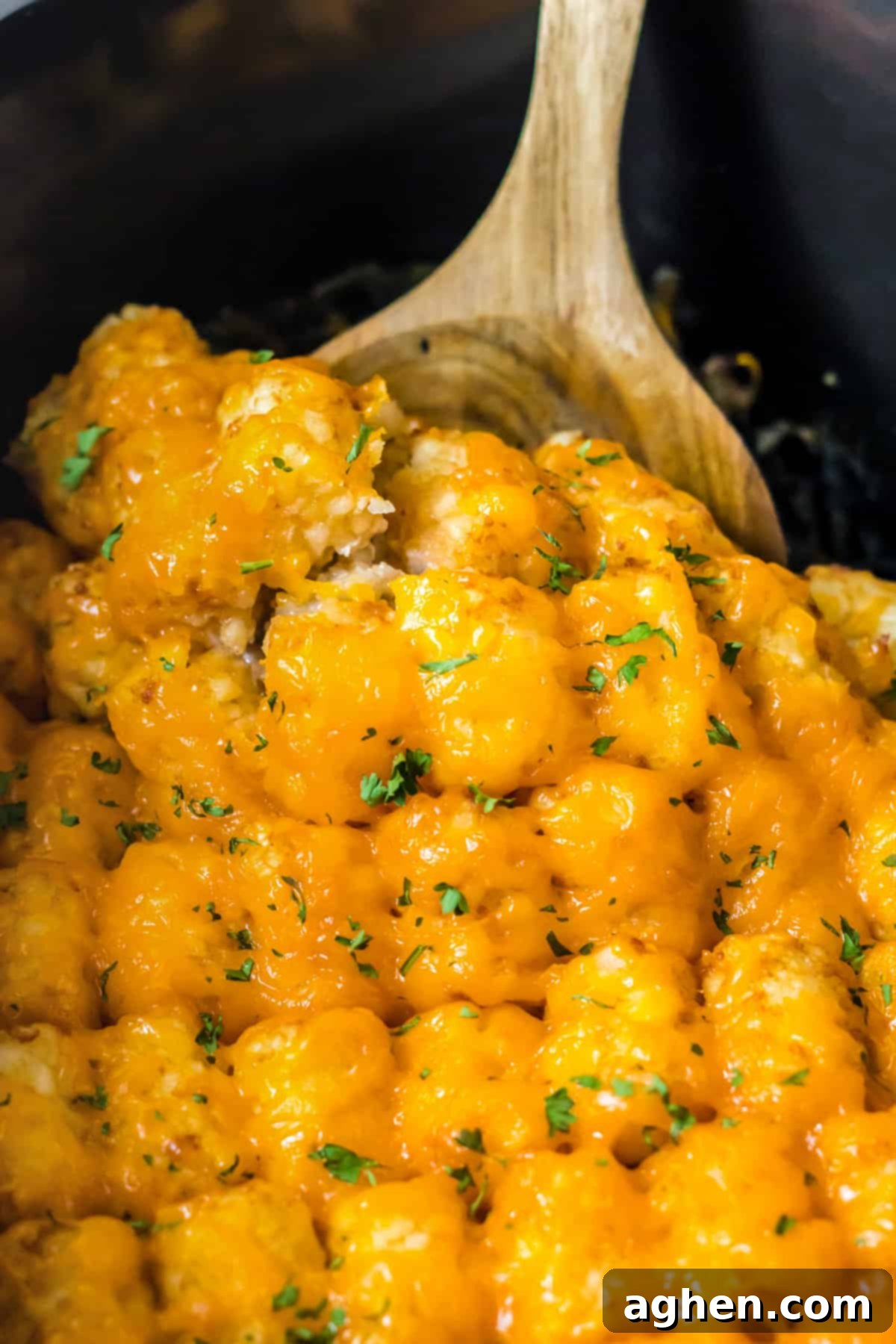 Effortless Tater Tot Comfort 8 Wooden spoon in slow cooker tater tot casseorle.