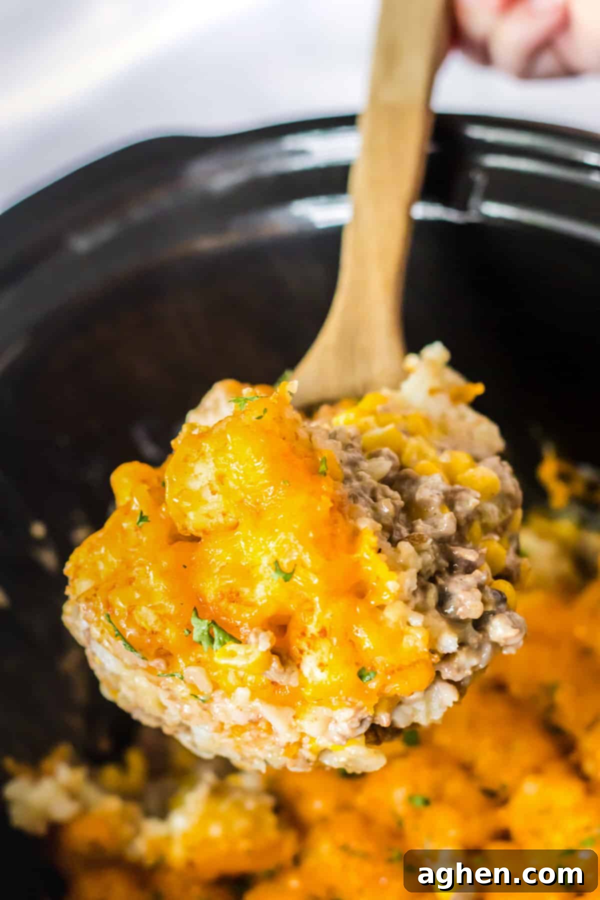 Effortless Tater Tot Comfort 10 Spoon scooping out serving of slow cooker tater tot casserole.