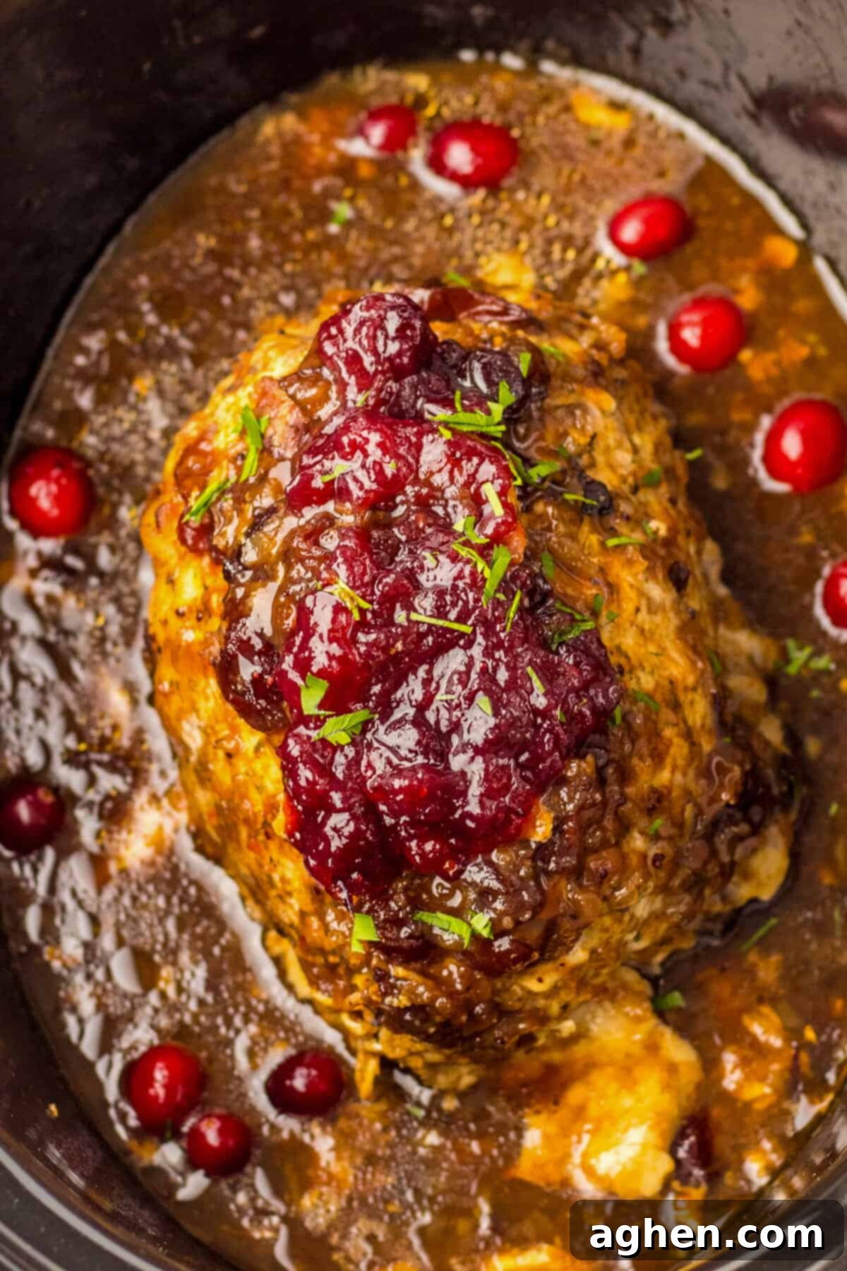 Slow Cooker boneless turkey breast roast cooked in cranberry sauce.