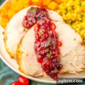 Sliced crock pot turkey roast with cranberry sauce.