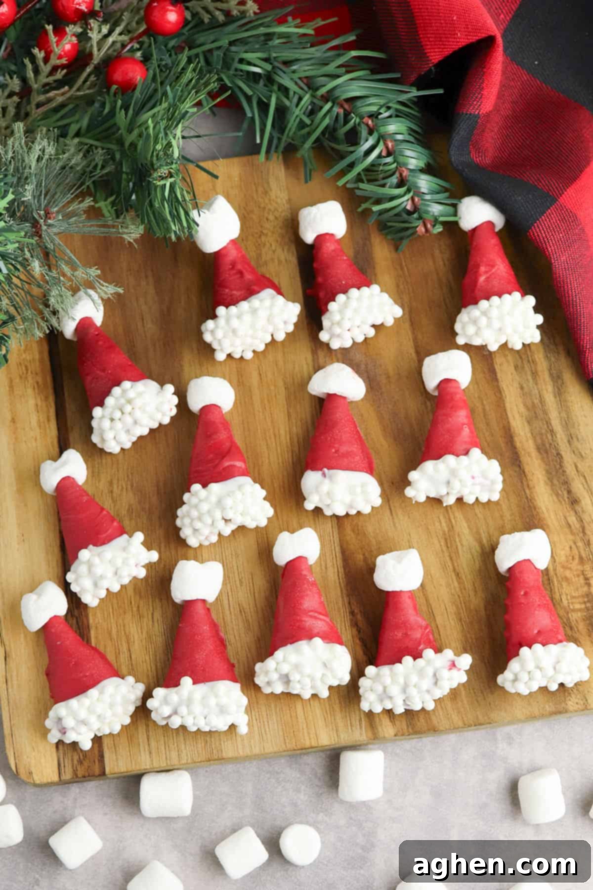 Easy no-bake Santa hat Bugles, bugle corn snacks dipped in red candy melts and decorated with white sprinkles and mini marshmallows to look like cute little santa hats!