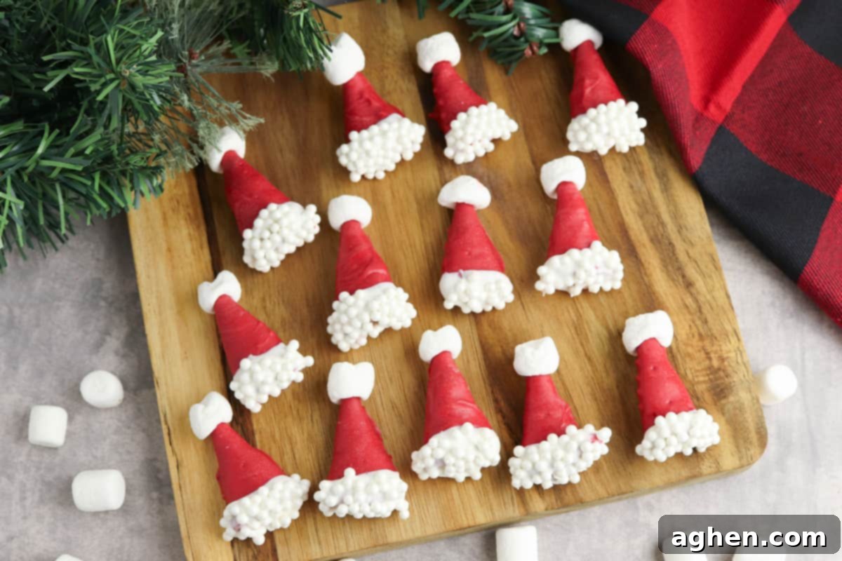 Bugles dipped in red chocolate and decorated with white spinkles and mini mashmallows to look like santa hats.
