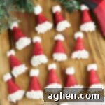 Bugle Santa Hats - Bugles dipped in red chocolate and decorated with white sprinkles and mini marshmallows to look like santa hats.