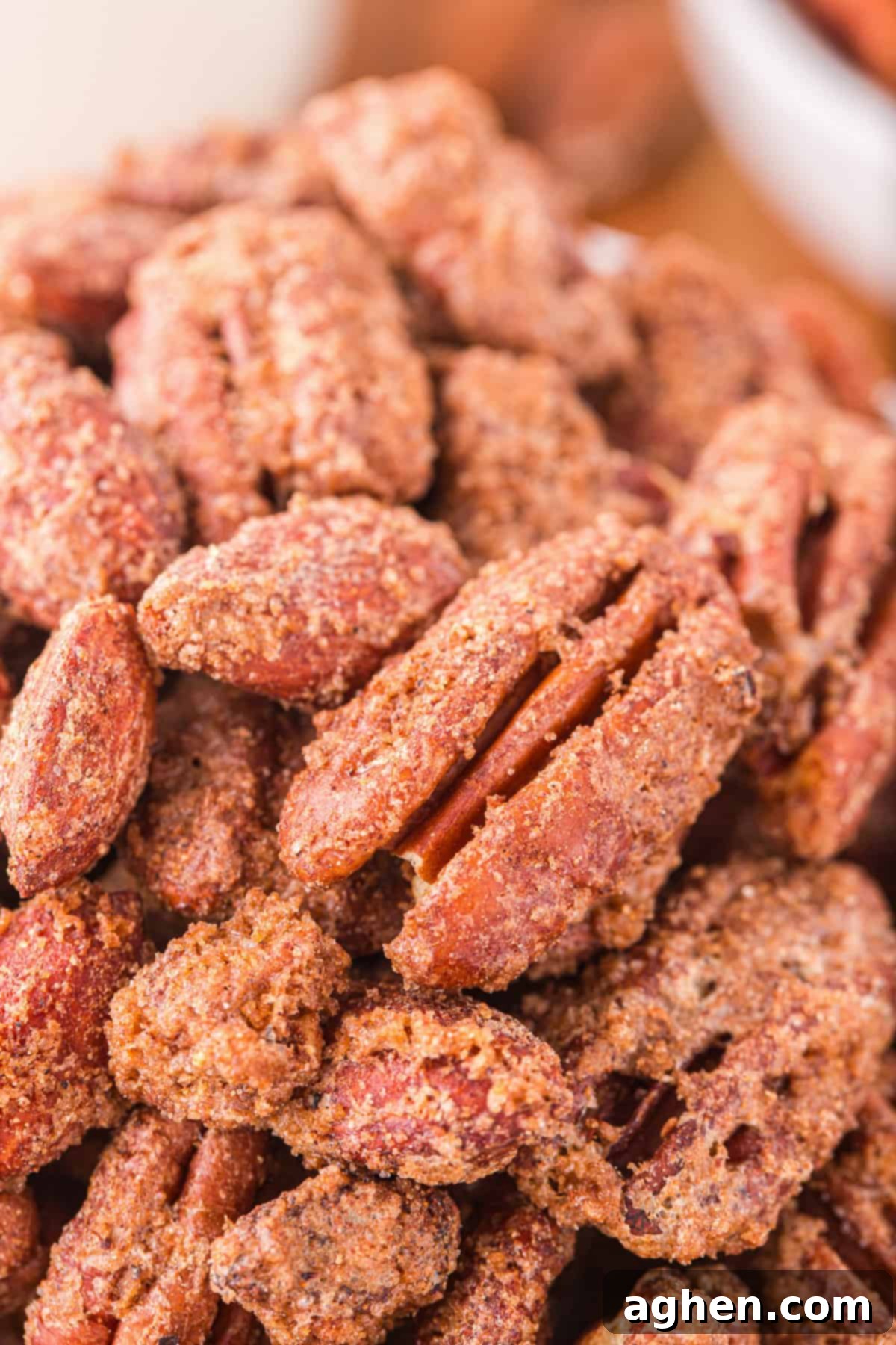 Close up of sweet and crunchy candied pecans and almonds, showing their perfectly caramelized coating.