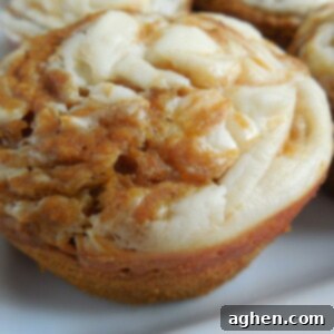 Pumpkin cream cheese muffin on white plate