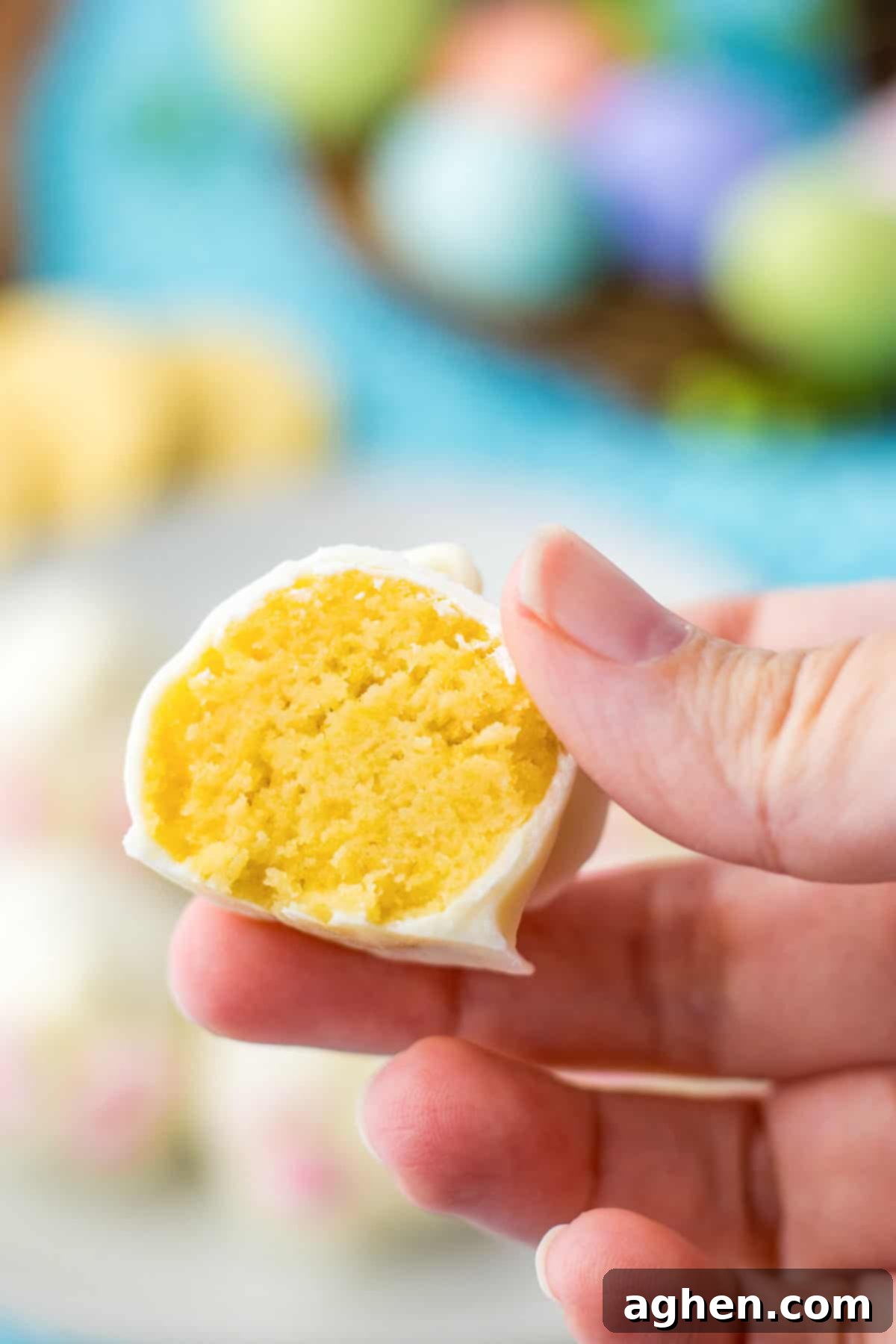 A Bunny Butt Oreo truffle, expertly cut in half to reveal its luscious lemon cookie filling and creamy texture, ready to be enjoyed.