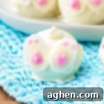 Oreo cookie truffles dipped in white chocolate and decorated with white chocolate feet and swirly tail to look like cute little bunny butts.