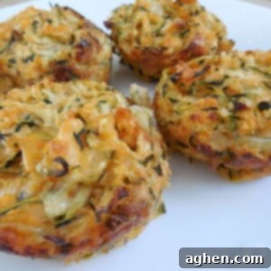 Close-up of a buffalo zucchini muffin on a white plate, showcasing its texture