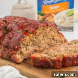 Lipton Onion Soup Mix Meatloaf with ketchup glaze and box of Lipton soup mix packets.