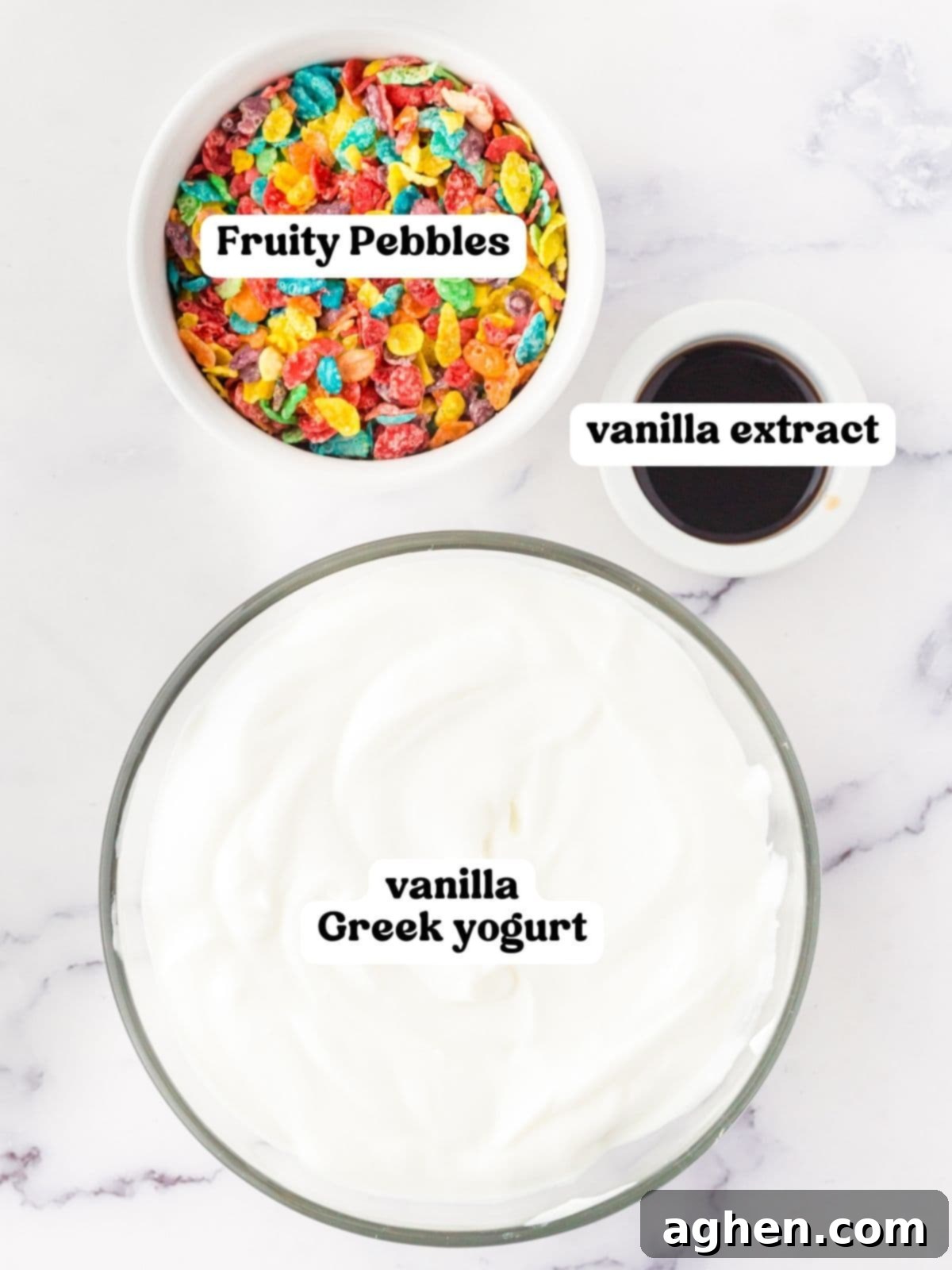 Bowls of Fruity Pebbles cereal, vanilla extract, and vanilla Greek Yogurt, ready for mixing.