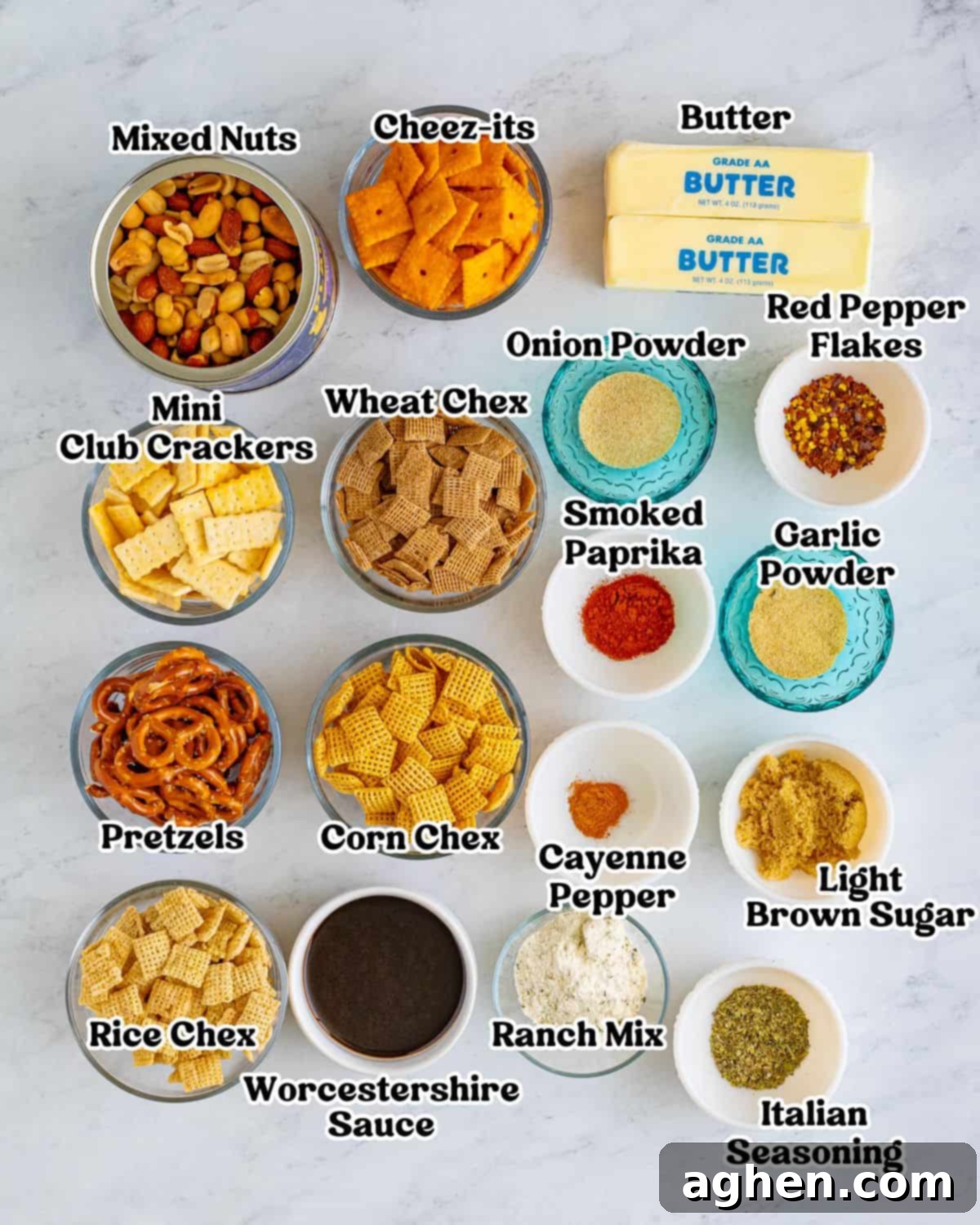 Zesty Crunch Medley 3 Labeled ingredients for chex mix recipe: mixed nuts cheeze-its, wheat chex, corn chex, rice chex, mini crackers, pretzels twists, two sticks of butter, ranch mix, light brown sugar and seasonings.
