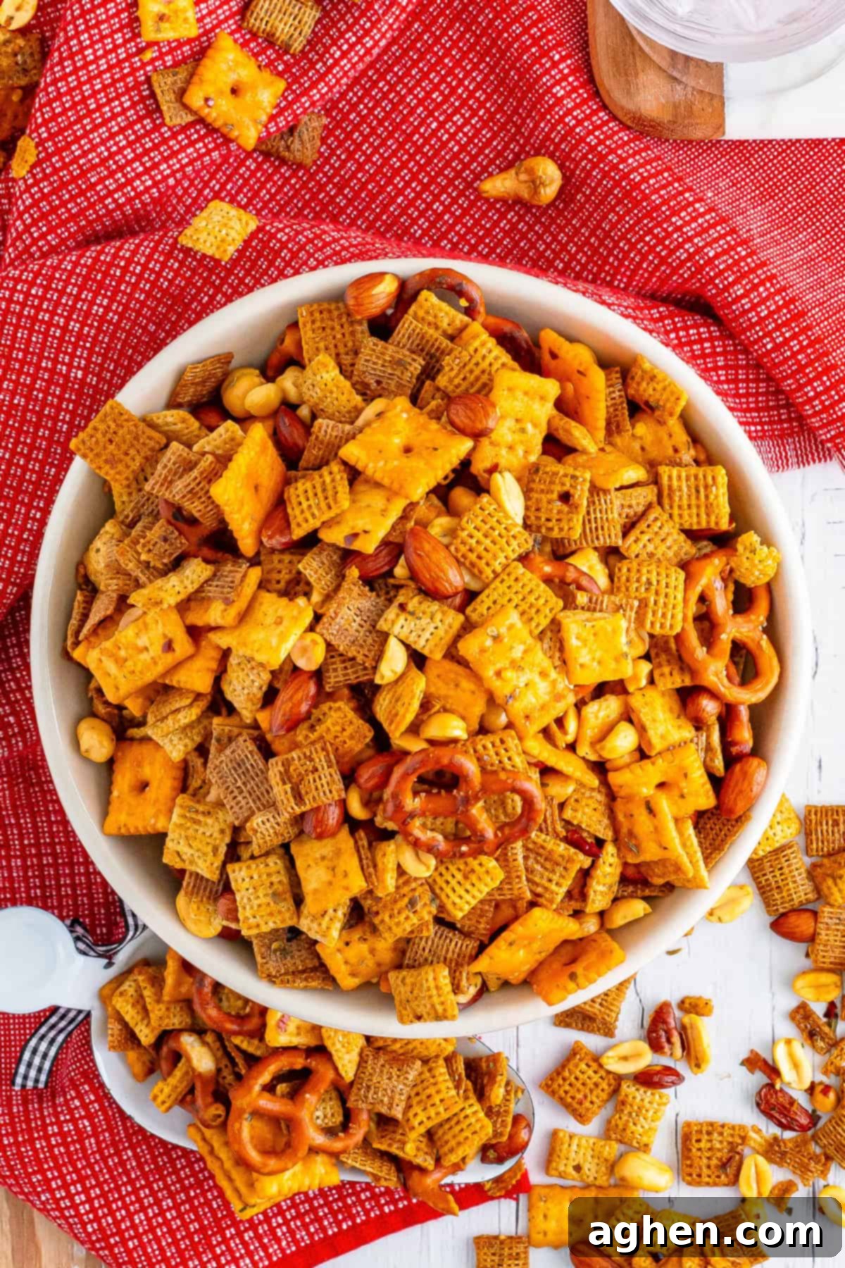 Zesty Crunch Medley 9 Overhead photo of the bowl of spicy firecracker chex mix with some of the snack mix scattered on the table around it.