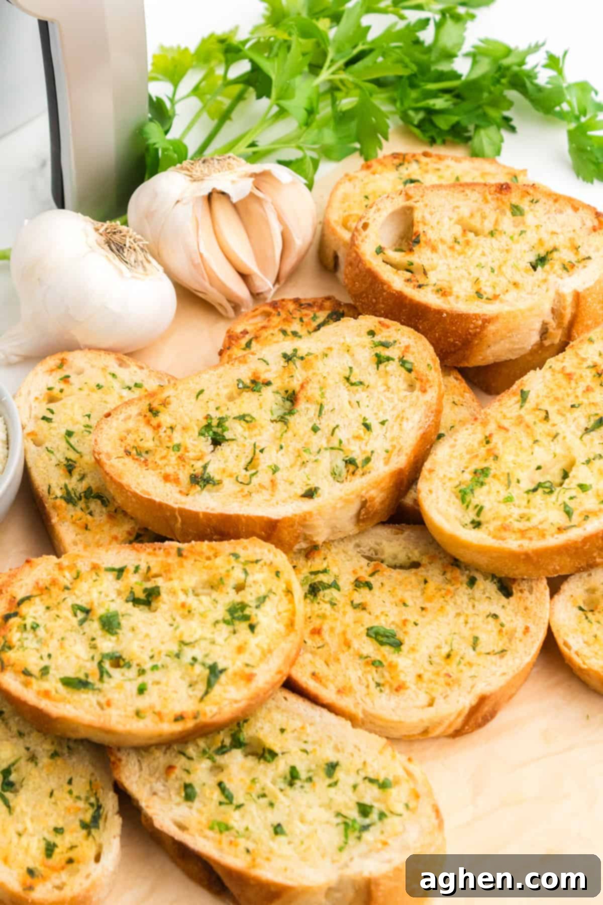 Thick slices of air fryer garlic bread with garlic, butter, Parmesan cheese, and parsley. 