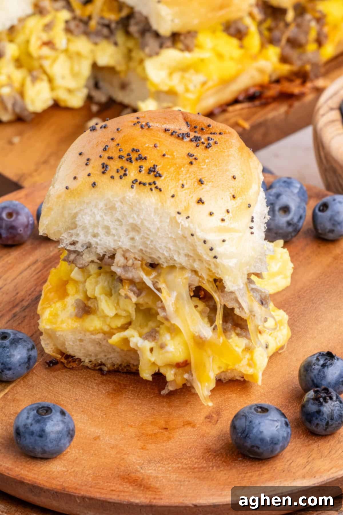 Sweet & Savory Hawaiian Breakfast Bake 9 A single, perfectly cooked breakfast sandwich nestled on a King's Hawaiian roll, showcasing the fluffy scrambled egg, savory crumbled sausage, and rich melted cheese, ready to be enjoyed as a satisfying morning treat.