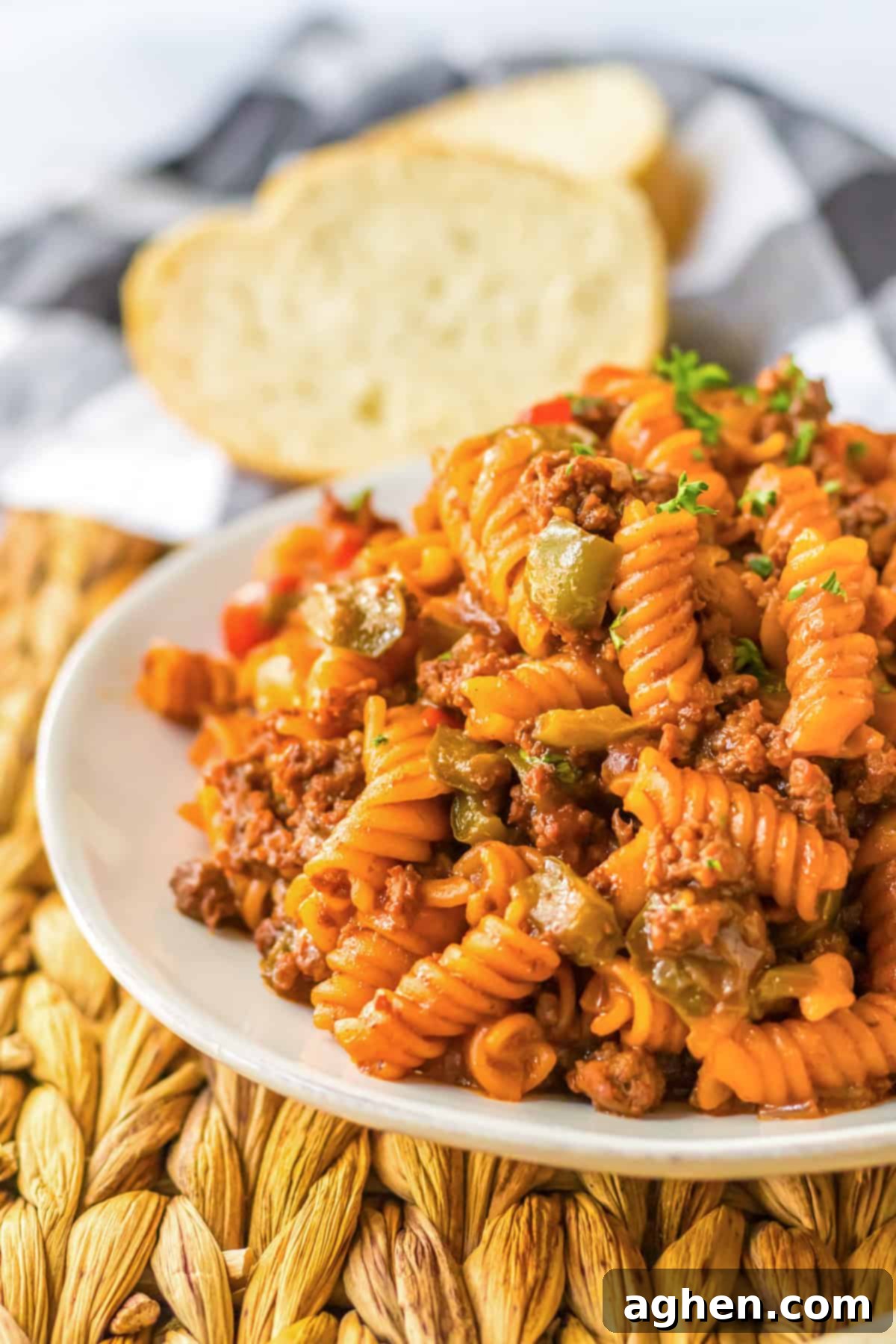 Hearty Sloppy Joe Pasta 8 A heaping serving of one-pot sloppy joe pasta with ground beef, rotini, and bell peppers, garnished with fresh parsley.