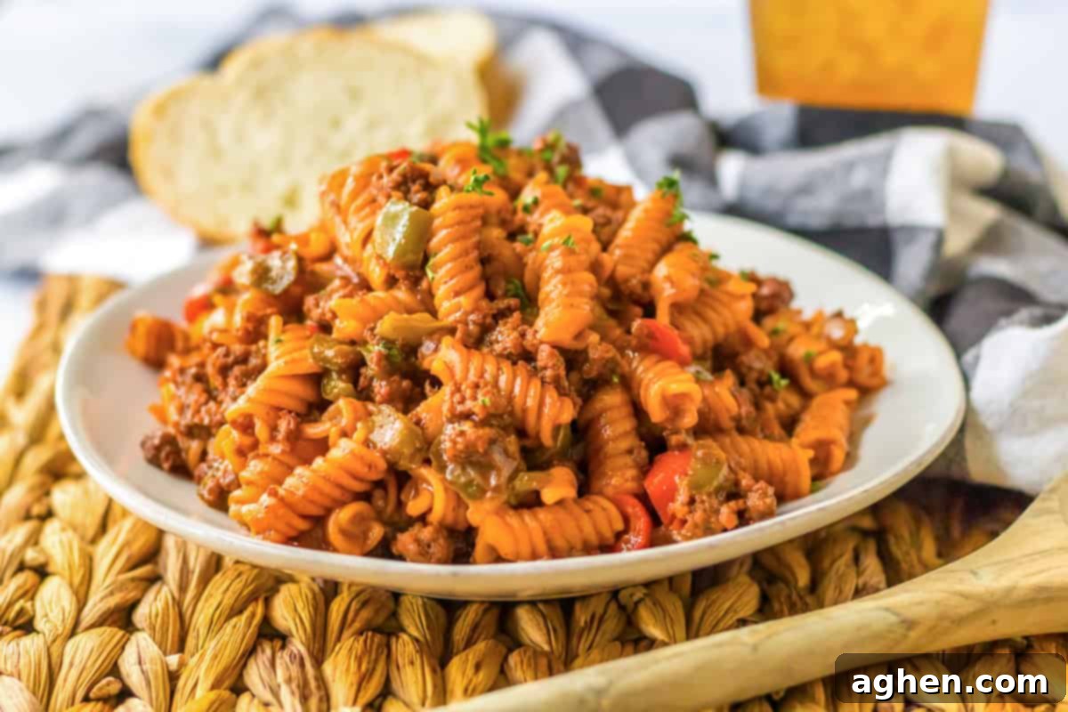 Hearty Sloppy Joe Pasta 9 A close-up of a plate of easy one-pot sloppy joe pasta, featuring rotini noodles, ground beef, bell peppers, onions, and a rich, homemade sloppy joe sauce.