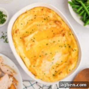 Party Potatoes with cream cheese surrounded by holiday meal including turkey, gravy, and green beans, capturing a festive and comforting scene.
