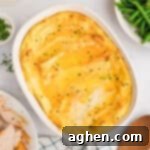 Party Potatoes with cream cheese surrounded by holiday meal including turkey, gravy, and green beans, a perfect comfort food.