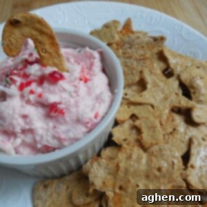 Peppermint Cannoli Bliss with Crispy Flatbread 2 Close-up of Candy Cane Cannoli Dip in a white bowl with a spoon, surrounded by Flatout crackers.