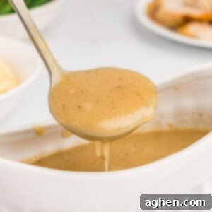 Easy homemade turkey gravy without drippings in spooned out of a gravy boat into a ladle.