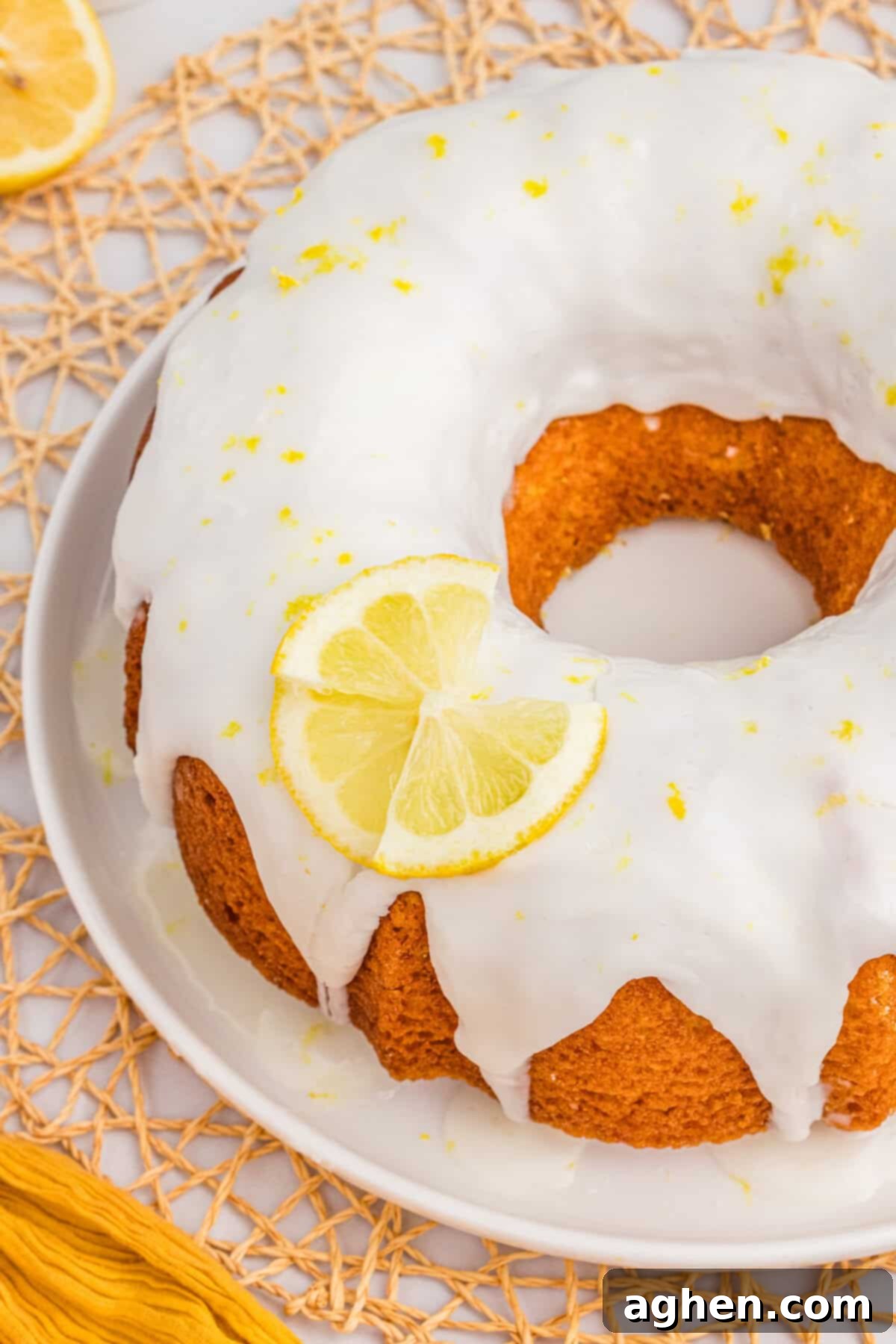 Effortless Lemon Bundt Cake Perfection 6 A stunningly moist Lemon Bundt Cake with a luscious Lemon Glaze Drizzled over the top, ready to be served.