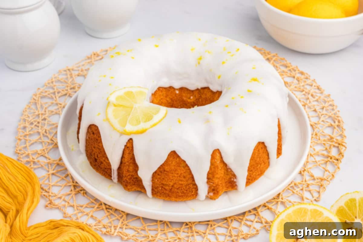 Effortless Lemon Bundt Cake Perfection 8 A beautifully decorated lemon bundt cake, generously covered with a thick, glistening glaze drizzled over its sculpted surface, ready to be enjoyed.