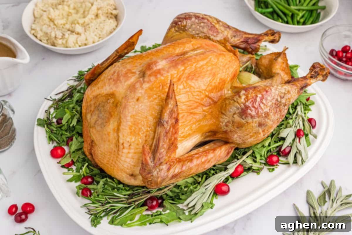 Roasted holiday turkey served on platter of greens with cranberries for garnish.
