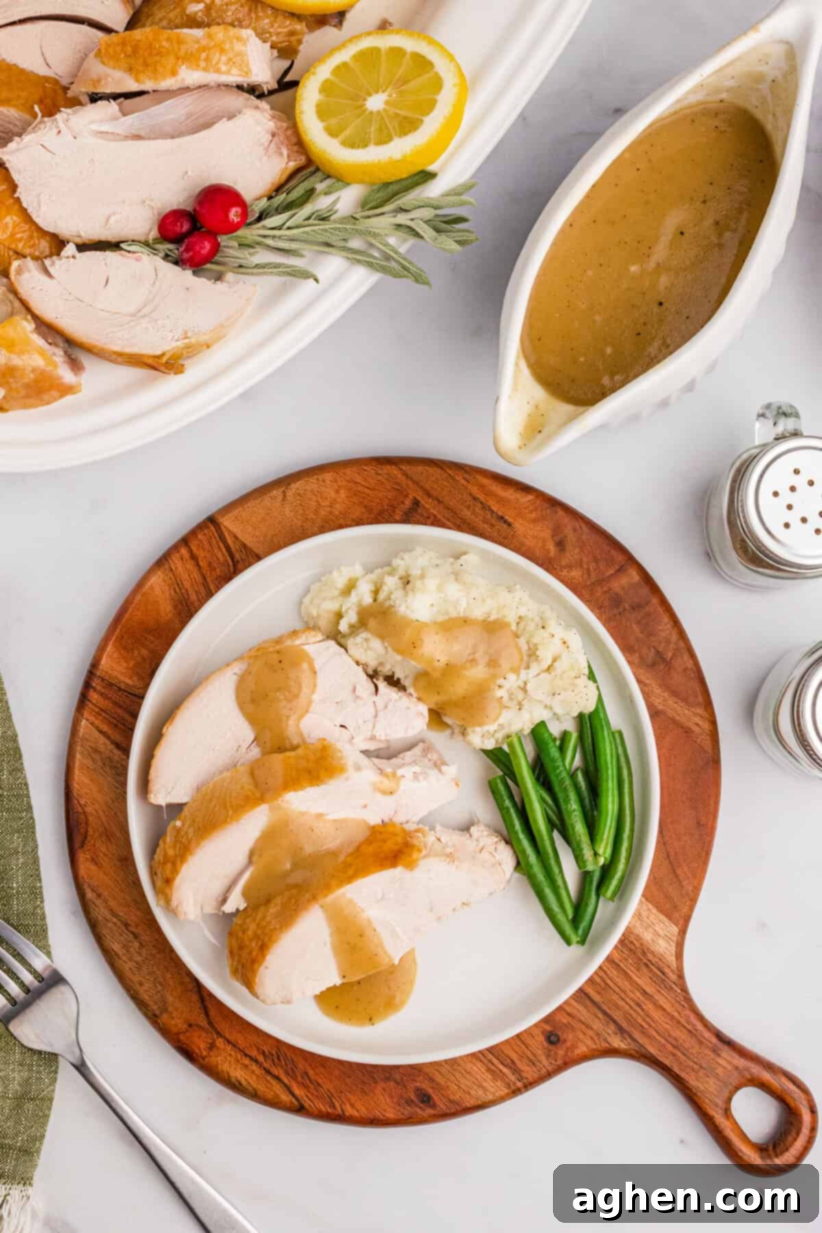 Thanksgiving roast turkey dinner with turkey neck gravy, mashed potatoes, and green beans.