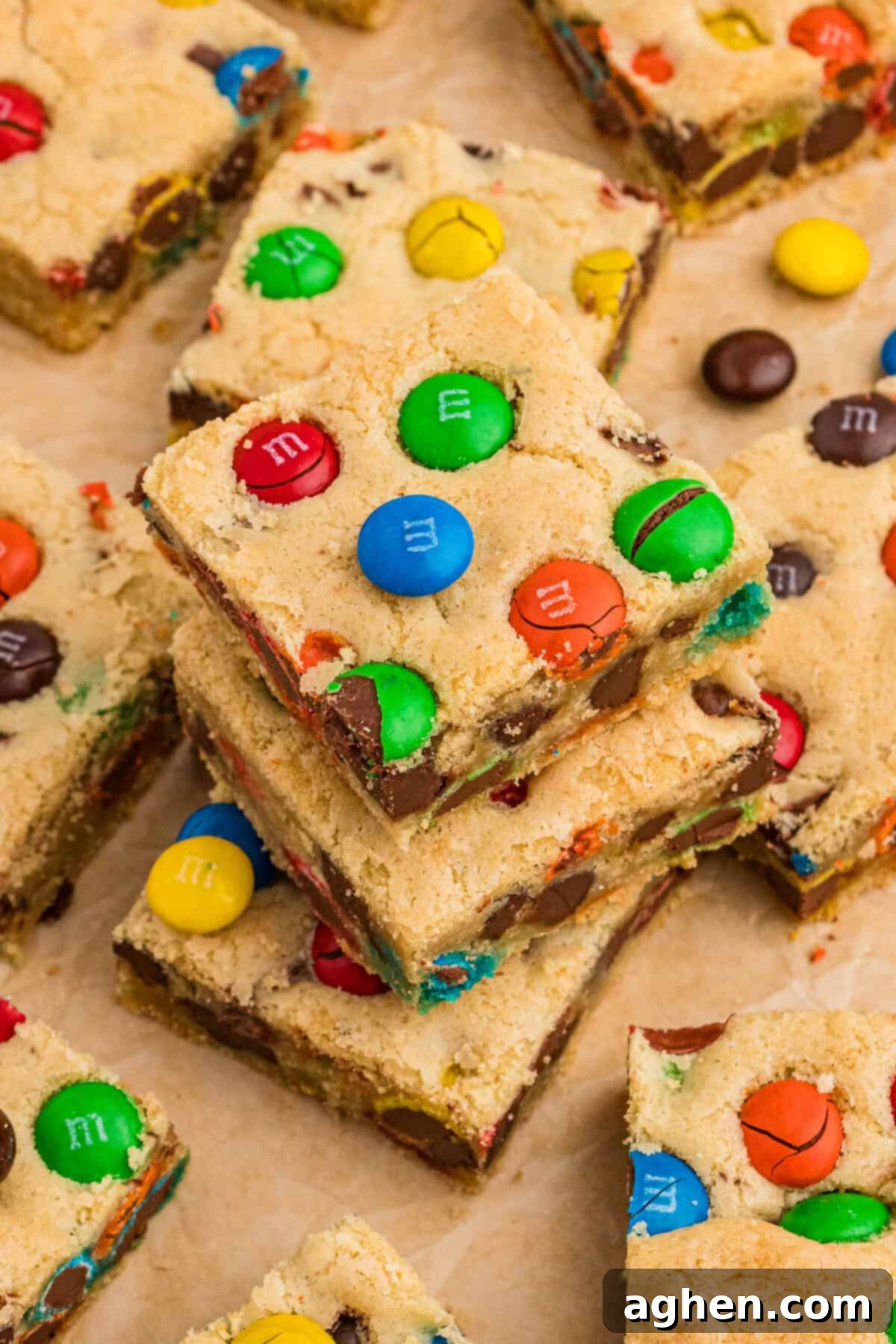 Cookie bars with M&Ms and chocolate chips, arranged artfully on parchment paper, ready for serving.